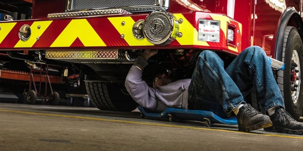 Vehicle Mechanic is going under to repair the damage parts