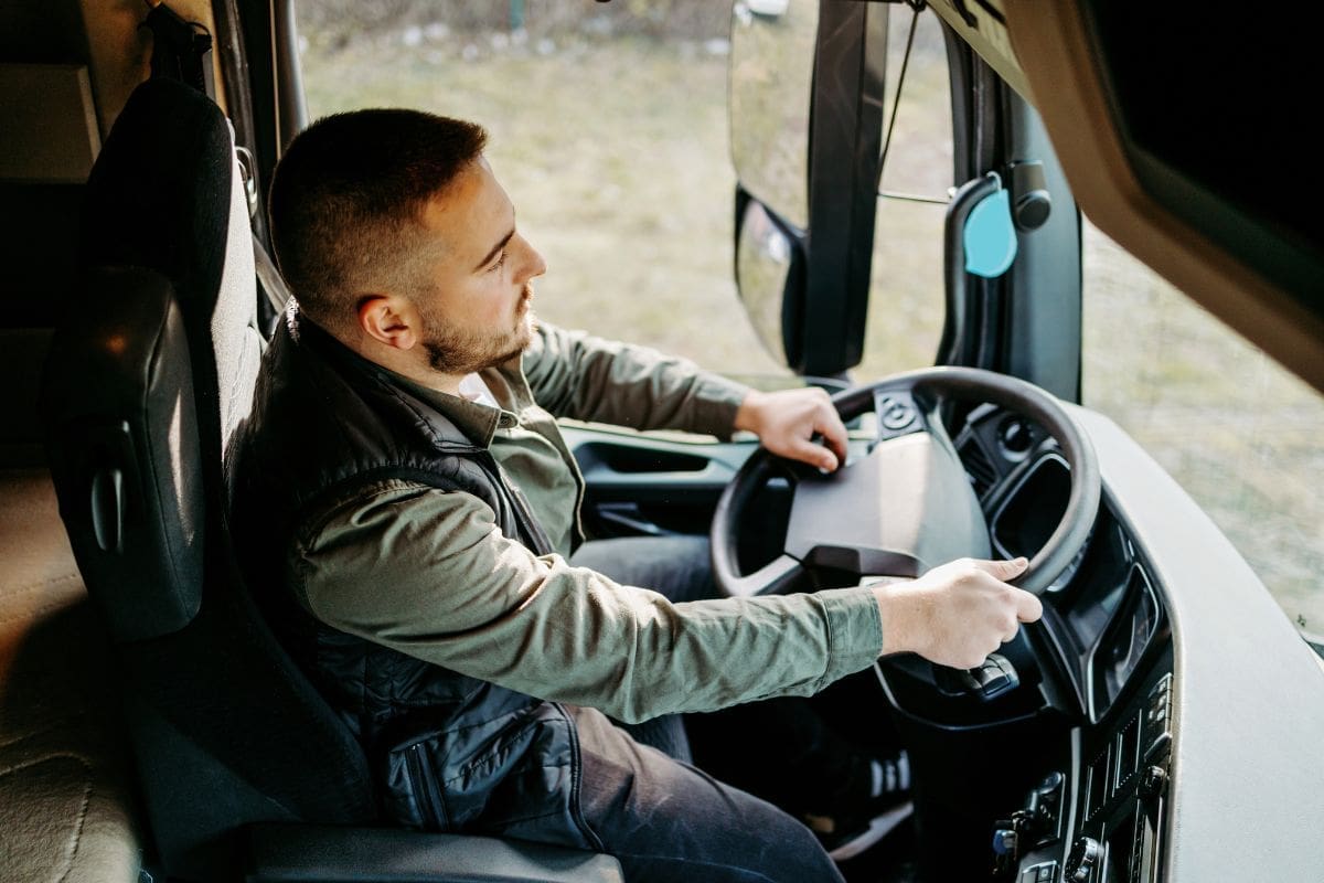 A man is wearing jacket while driving