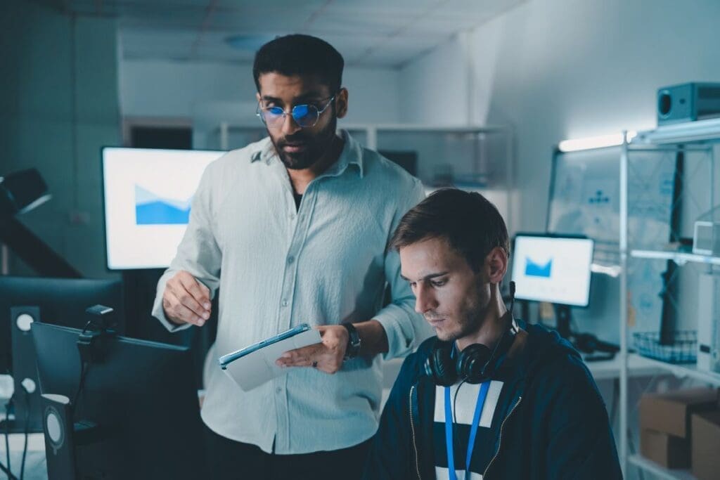 Showing a professional man mid age teaching his colleague
