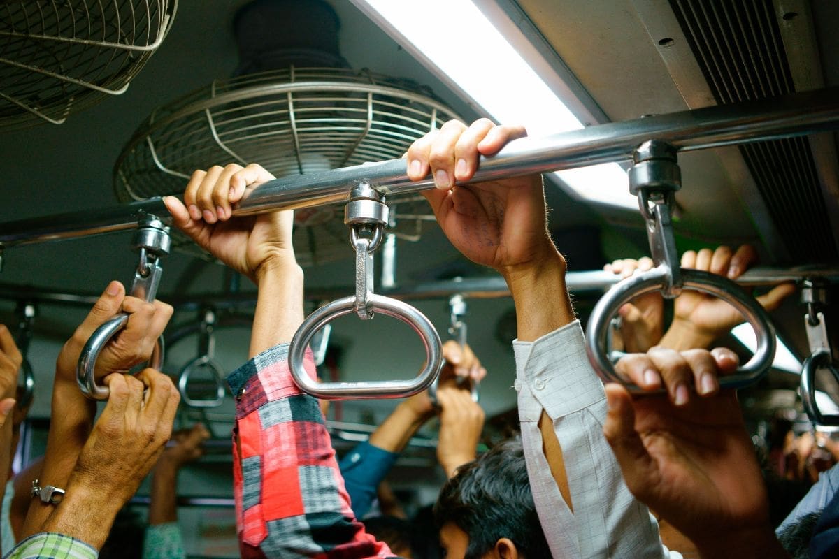 commuters holding onto rail to keep on balance
