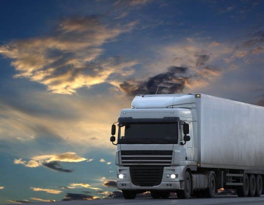 Big White truck is still on the road as the dark comes in